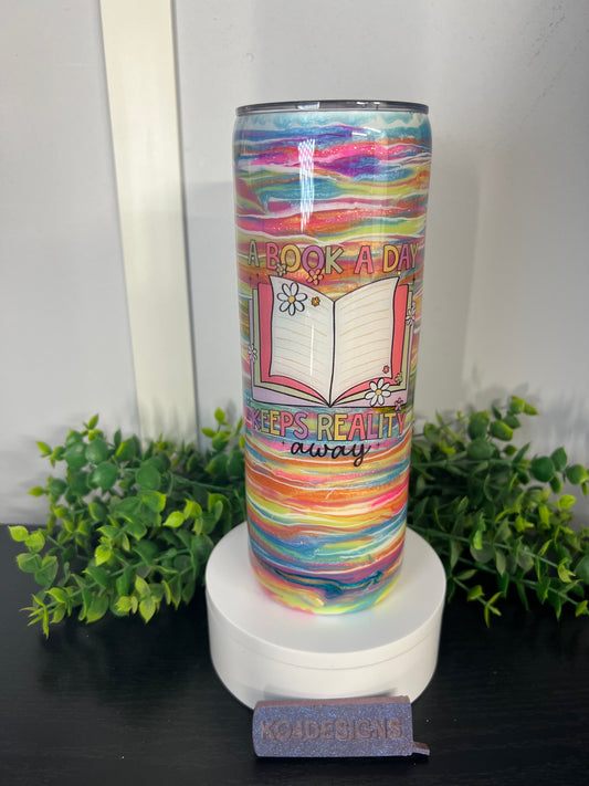 20oz skinny - blues/pinks/yellows/orange/light green “A Book A Day Keeps Reality Away”